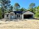 Unfinished single Gathering house has an attached garage with a white front door at 12 Guava Terrace Radl, Ocklawaha, FL 32179