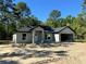 Unfinished single Gathering house has an attached garage with a white front door at 12 Guava Terrace Radl, Ocklawaha, FL 32179