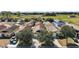 Aerial view of a neighborhood with houses surrounded by green fields, offering a sense of community and open space at 12340 Ne 48Th Loop, Oxford, FL 34484