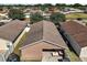 Aerial view of the back of the home and backyard with patio furniture, showcasing the outdoor living space at 12340 Ne 48Th Loop, Oxford, FL 34484