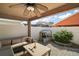 Cozy back patio area with comfortable seating, a ceiling fan, and a charming playhouse, perfect for outdoor relaxation at 12340 Ne 48Th Loop, Oxford, FL 34484