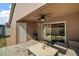 Covered back patio featuring outdoor seating, a ceiling fan, and a grill, ideal for entertaining guests and enjoying the outdoors at 12340 Ne 48Th Loop, Oxford, FL 34484