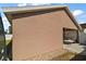 View of the side and back of the house, showcasing the back patio and low-maintenance landscaping at 12340 Ne 48Th Loop, Oxford, FL 34484