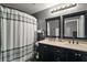 Stylish bathroom featuring dual sinks, modern fixtures, and a shower-tub combination at 12340 Ne 48Th Loop, Oxford, FL 34484