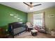 Cozy Bedroom with a crib, glider, and charming decorations creating a warm atmosphere at 12340 Ne 48Th Loop, Oxford, FL 34484