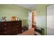 Cozy bedroom with dark wood dresser, bookshelf, and closet, offering practical storage and a playful atmosphere at 12340 Ne 48Th Loop, Oxford, FL 34484