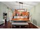 Well-lit dining area featuring a stylish table set, seamlessly connected to the kitchen and living room at 12340 Ne 48Th Loop, Oxford, FL 34484