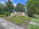 Community entrance sign surrounded by lush landscaping, welcoming you to this vibrant neighborhood at 12340 Ne 48Th Loop, Oxford, FL 34484