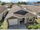 Charming single-story home with a well-maintained lawn, an attached garage, and manicured landscaping at 12340 Ne 48Th Loop, Oxford, FL 34484