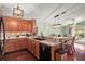 Open kitchen showcasing wood cabinetry, modern appliances, and seamless flow to the living area at 12340 Ne 48Th Loop, Oxford, FL 34484