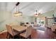 Inviting living room with a dining area featuring hardwood floors, high ceilings, and lots of natural light at 12340 Ne 48Th Loop, Oxford, FL 34484