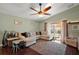 Bright living room with a comfortable white sofa, large area rug, and sliding glass doors to the patio at 12340 Ne 48Th Loop, Oxford, FL 34484