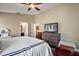 Comfortable main bedroom featuring a large bed, dresser, and access to the ensuite bathroom at 12340 Ne 48Th Loop, Oxford, FL 34484