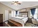 Spacious main bedroom with a large bed, a sitting area, and plenty of natural light at 12340 Ne 48Th Loop, Oxford, FL 34484
