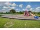 Community playground with slides and swings, offering fun outdoor activities for children in a safe environment at 12340 Ne 48Th Loop, Oxford, FL 34484