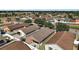 Aerial view of a backyard with a white fence, complemented by neighboring houses and lush greenery at 12340 Ne 48Th Loop, Oxford, FL 34484