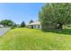 Expansive backyard showcasing lush green lawn and a covered patio of the home at 13045 Colonnade Cir, Clermont, FL 34711