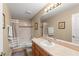 Well-lit bathroom with vanity, shower with a tub combo offers a cozy and functional space at 13045 Colonnade Cir, Clermont, FL 34711
