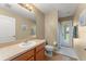 Cozy bathroom with a single sink vanity, toilet, and walk-in shower, offers great privacy at 13045 Colonnade Cir, Clermont, FL 34711