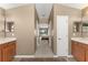 Hallway between dual vanities leads to the primary bedroom and features natural light at 13045 Colonnade Cir, Clermont, FL 34711