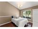 Cozy guest bedroom with a large bright window features a vaulted ceiling at 13045 Colonnade Cir, Clermont, FL 34711
