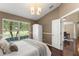 Cozy bedroom with bright natural light, a white wardrobe, and wood floors offer a tranquil retreat at 13045 Colonnade Cir, Clermont, FL 34711