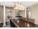 Open dining area with views to a game room, features an elegant dark wood table and bright lighting at 13045 Colonnade Cir, Clermont, FL 34711