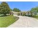 Beautiful one-story home with lush landscaping and a long driveway at 13045 Colonnade Cir, Clermont, FL 34711