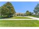 Inviting single-Gathering home with lush landscaping, large trees, and a driveway at 13045 Colonnade Cir, Clermont, FL 34711