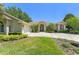Lovely home with landscaped yard, mature trees, and a circular driveway at 13045 Colonnade Cir, Clermont, FL 34711