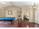 The game room is open and spacious with a view to the primary bedroom at 13045 Colonnade Cir, Clermont, FL 34711