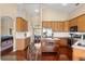 Open concept kitchen with wood cabinets, stainless steel appliances, and a clear view of the breakfast nook at 13045 Colonnade Cir, Clermont, FL 34711