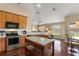 Bright kitchen featuring wood cabinets, stainless steel appliances, white countertops, and wood floors at 13045 Colonnade Cir, Clermont, FL 34711