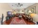 Comfortable living room featuring a leather sofa, wood floors, natural light, and traditional decor at 13045 Colonnade Cir, Clermont, FL 34711