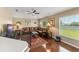 Cozy living room featuring a leather sofa, wood floors, and natural lighting at 13045 Colonnade Cir, Clermont, FL 34711