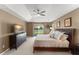 Relaxing main bedroom features neutral colors and a sliding door to a screened patio at 13045 Colonnade Cir, Clermont, FL 34711