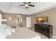 The spacious primary bedroom features a king bed and TV, with access to the primary bath at 13045 Colonnade Cir, Clermont, FL 34711