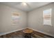 Bedroom with wood flooring, two windows with blinds, tan walls, and baseboards; perfect for relaxing at 13328 Lake Yale View Loop, Grand Island, FL 32735
