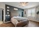 Cozy bedroom featuring a decorative ceiling fan, wood floors, a window, and an ensuite bathroom at 13328 Lake Yale View Loop, Grand Island, FL 32735