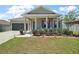Charming home with a covered porch, manicured landscaping, and inviting curb appeal at 13328 Lake Yale View Loop, Grand Island, FL 32735