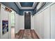 Stylish hallway with hardwood floors, board and batten walls, and decorative hooks at 13328 Lake Yale View Loop, Grand Island, FL 32735