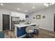 Bright eat-in kitchen boasts a marble island, stainless steel appliances, white cabinetry and wood flooring at 13328 Lake Yale View Loop, Grand Island, FL 32735