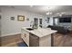 Open kitchen with a marble countertop island flowing to the living room and stainless steel appliances at 13328 Lake Yale View Loop, Grand Island, FL 32735