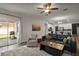 Open-concept living room with sliding doors to the patio, flowing into a modern kitchen at 13328 Lake Yale View Loop, Grand Island, FL 32735
