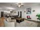 Inviting living room featuring a large sofa, modern furnishings, and seamless flow to the kitchen at 13328 Lake Yale View Loop, Grand Island, FL 32735