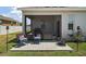 Relaxing screened patio with comfortable seating and an outdoor fire pit at 13328 Lake Yale View Loop, Grand Island, FL 32735