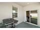 Covered patio includes an outdoor grill and sliding glass doors leading inside at 13328 Lake Yale View Loop, Grand Island, FL 32735