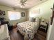 Bedroom boasts a bright quilt and hard surface floors and ceiling fan at 1616 Lauren Ln, Lady Lake, FL 32159