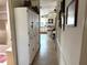 Hallway view showing built in cabinets and tile floor leading to kitchen at 1616 Lauren Ln, Lady Lake, FL 32159
