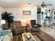 Comfortable living room area with cozy seating, natural light, and seamless flow to the dining area at 1616 Lauren Ln, Lady Lake, FL 32159